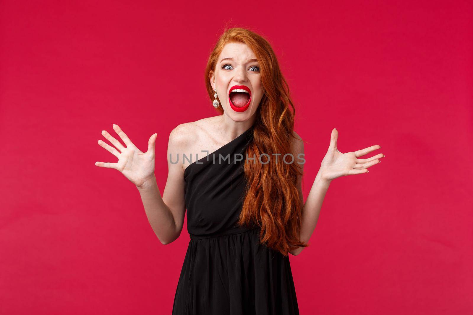Tensed and aggressive, pissed-off young redhead woman found out best friend slept with her boyfriend, arguing having argument and confrontation on party, screaming at person, red background.