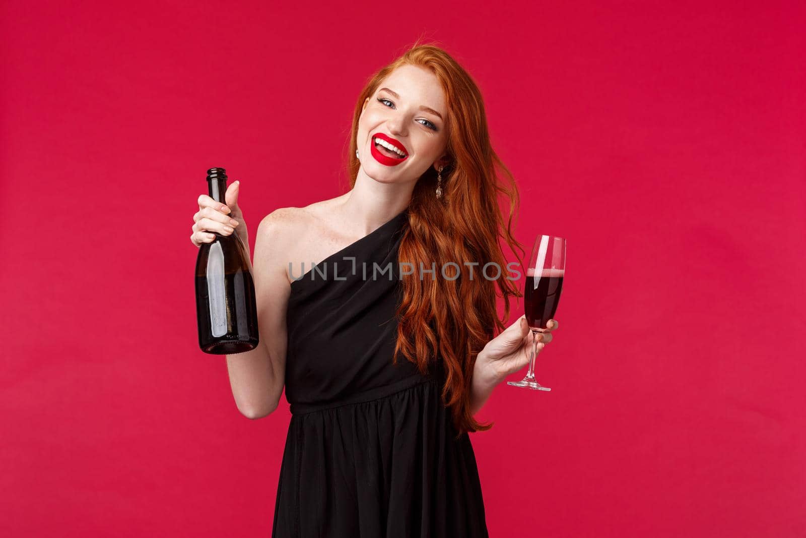 Portrait of carefree gorgeous redhead woman partying with friends, drinking from glass, holding bottle champagne and dancing during bachelorette night, smiling camera wear black dress by Benzoix