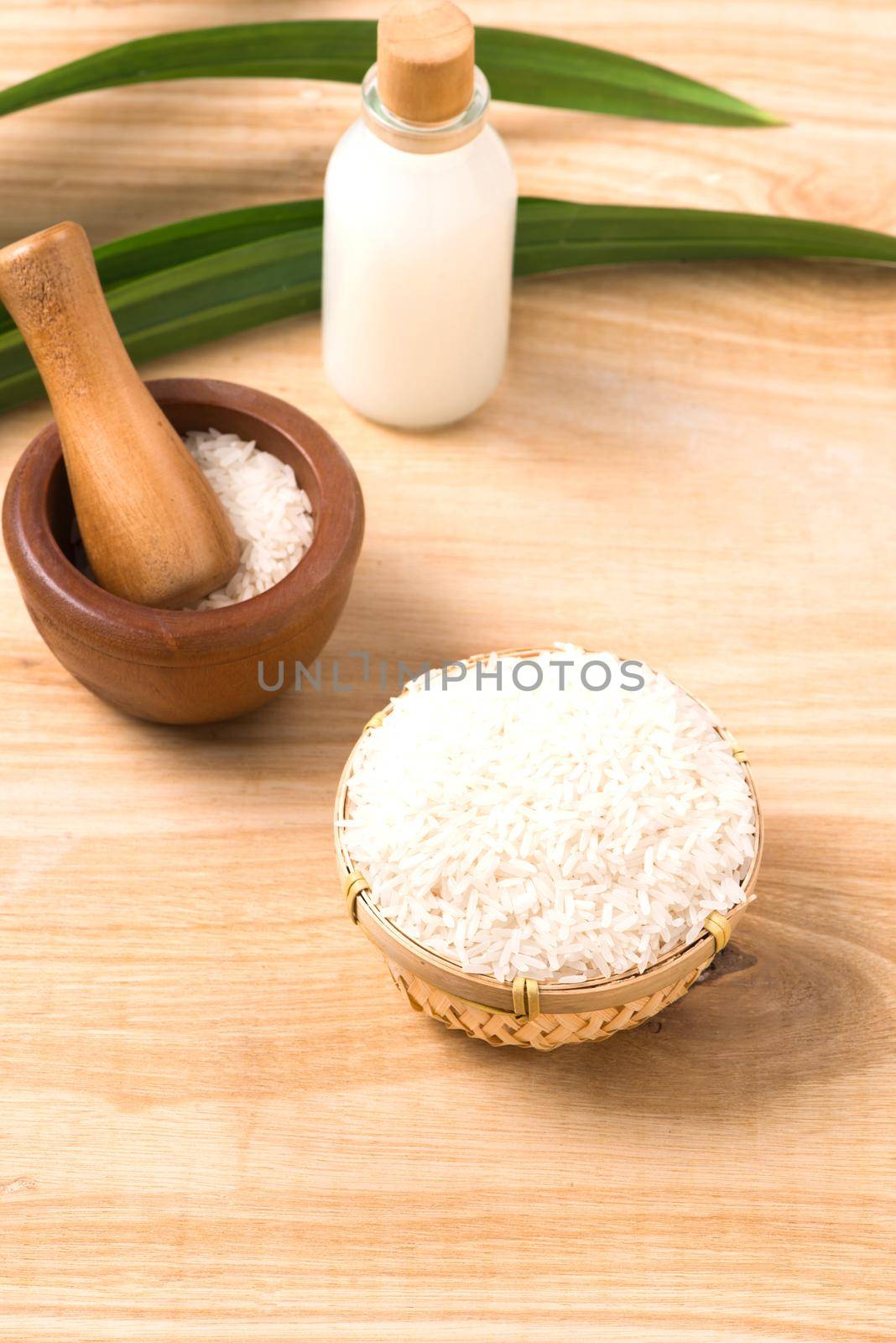 Rice milk and rice seeds on wooden table background.