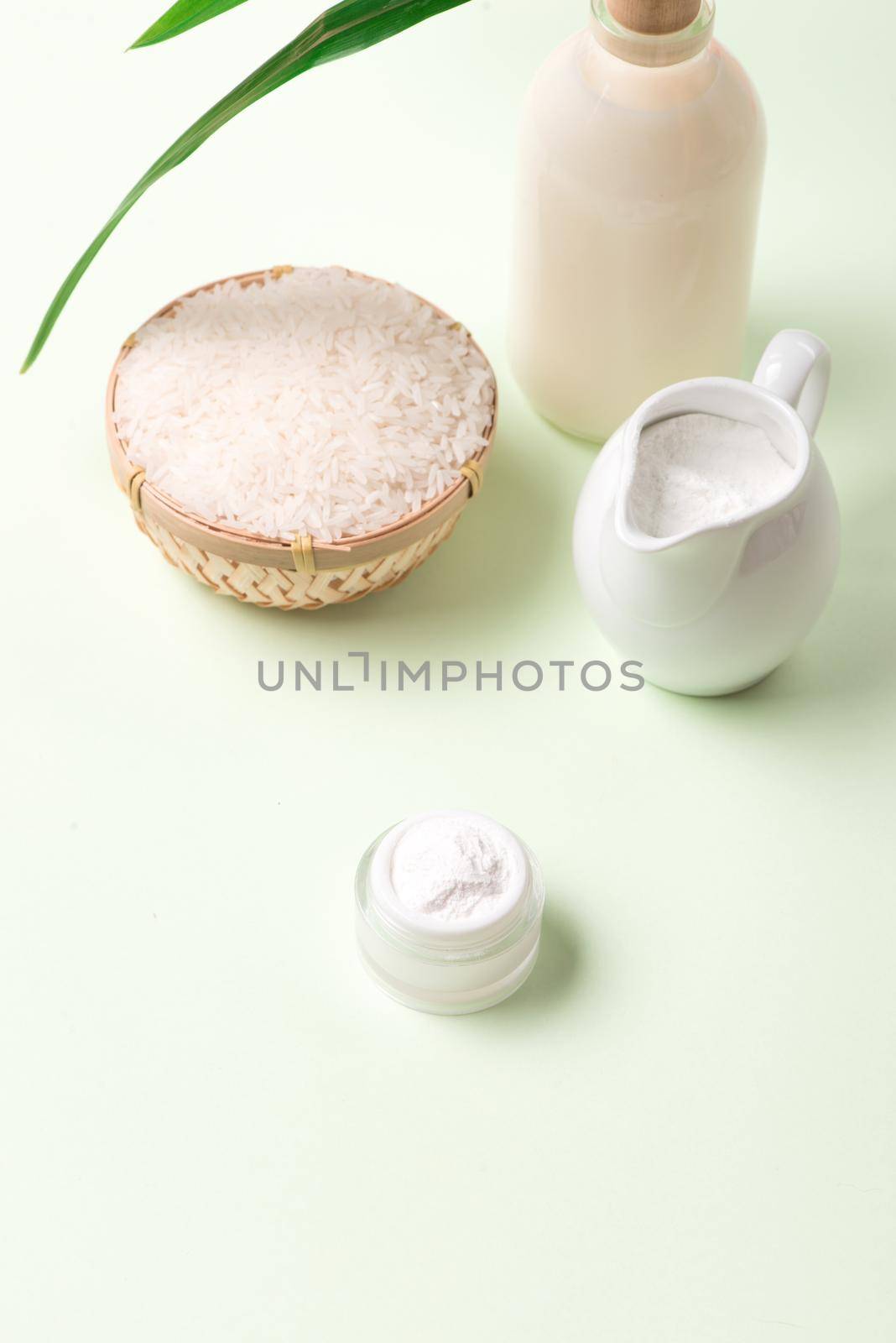 Vegan rice milk, non dairy alternative milk in a glass bottle close up by makidotvn