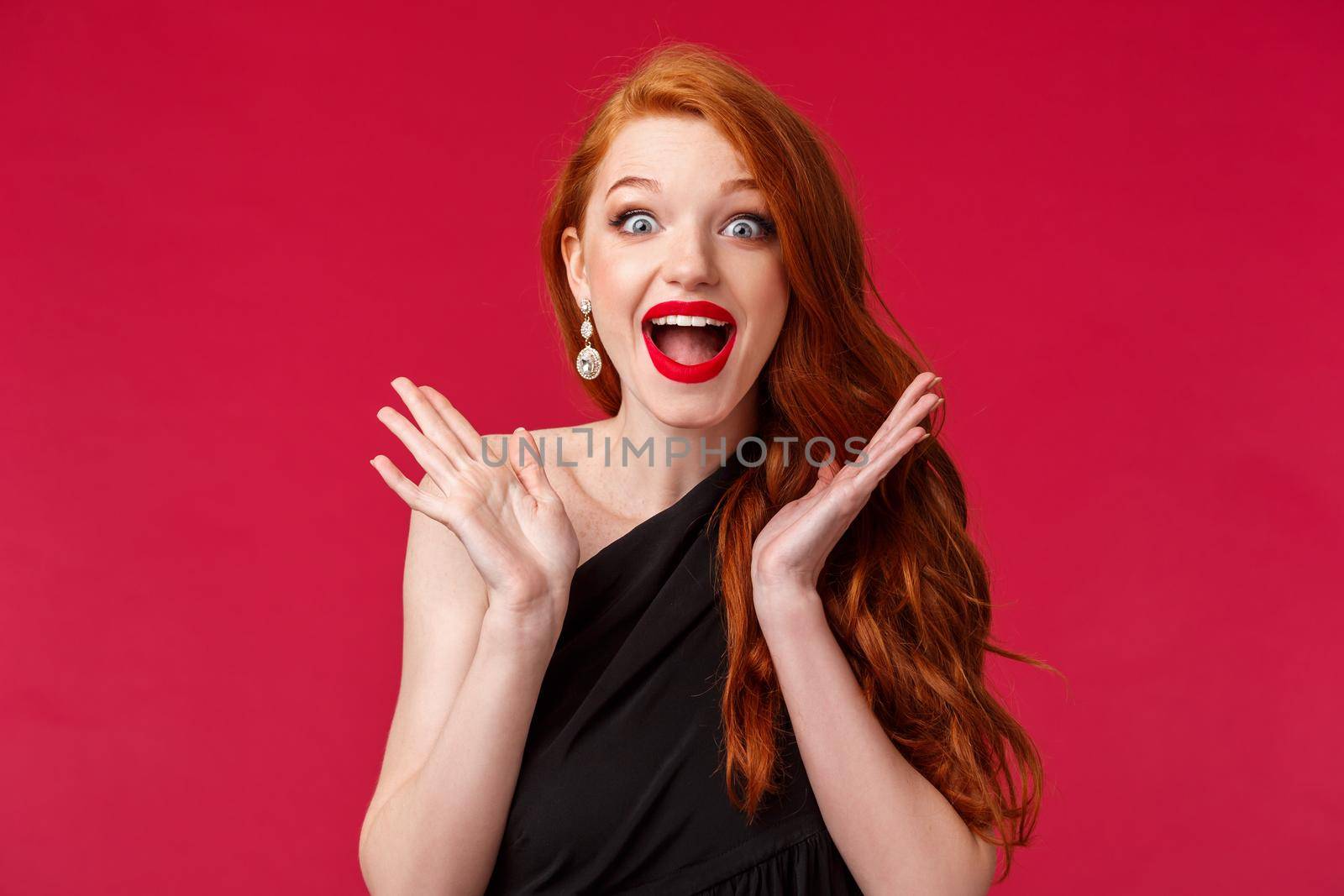Excited charismatic redhead woman triumphing look glad and happy for person winning award, applause happily smiling surprised and fascinated, clap after hearing incredible performance, black dress by Benzoix