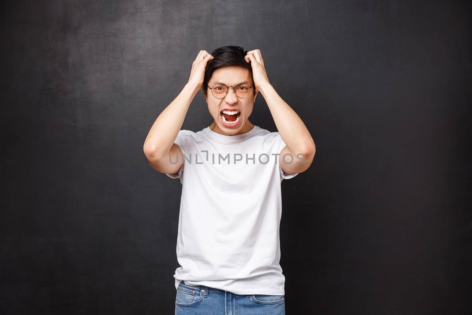 Angry and pissed-off bothered young asian guy losing temper, screaming outraged, ripping hair out of head and grimacing aggressive, feel distressed and tensed, hateful expression by Benzoix