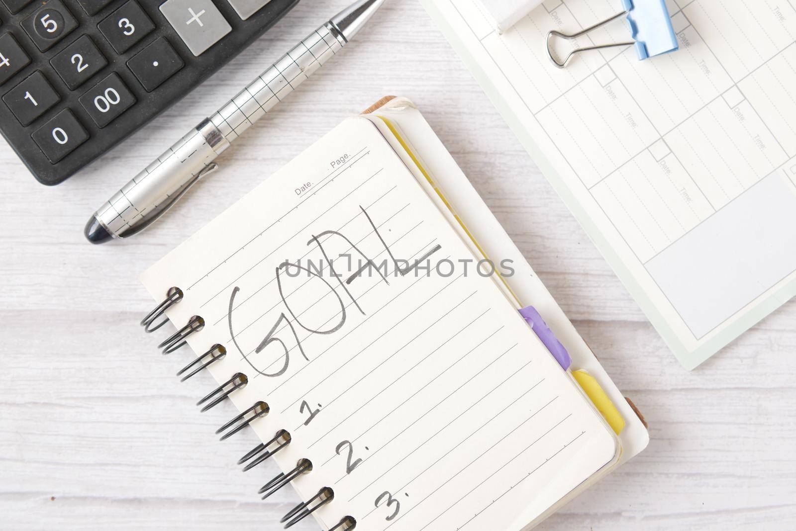 2022 new year goals on notepad on table ,