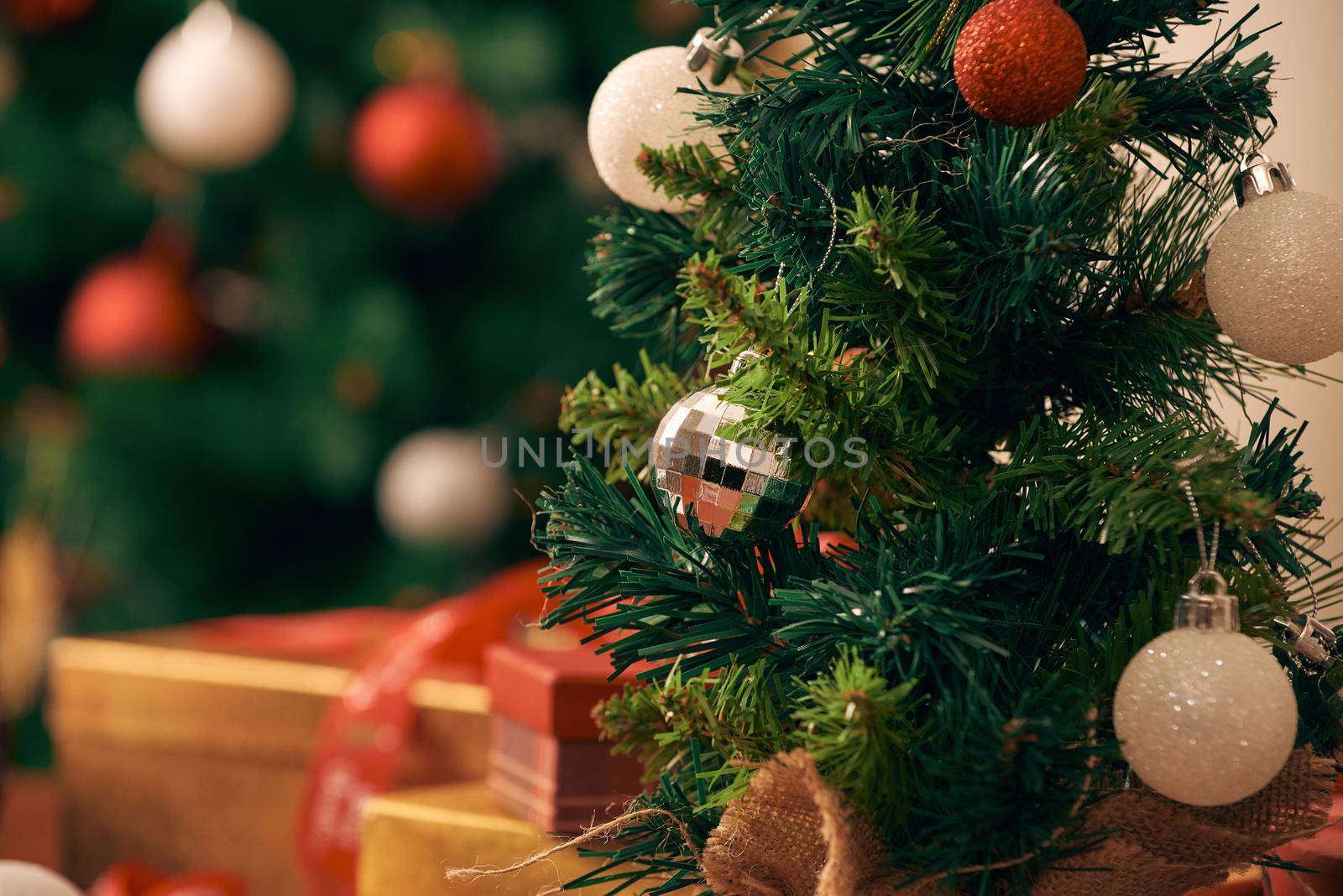 Decorating Christmas tree on bright background