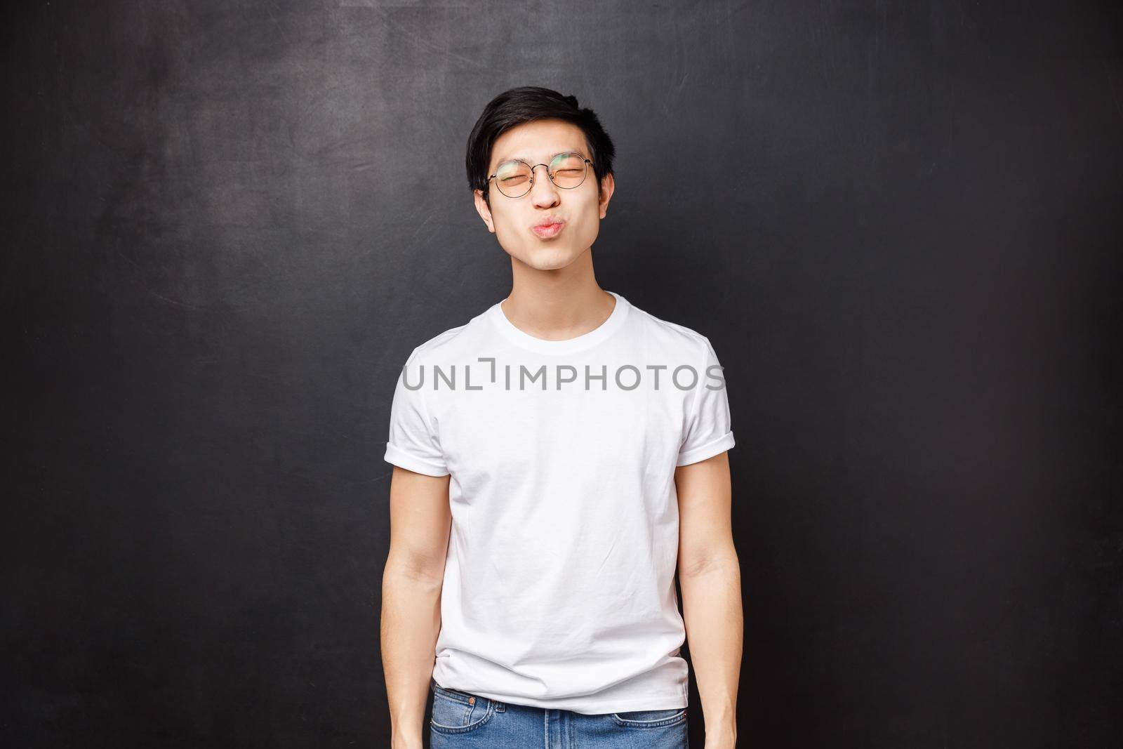 Relationship, romance and couple concept. Cute silly asian boyfriend close eyes and pouting lips prepared for first kiss, want to giggle and smile, having his first date with girl he loves.