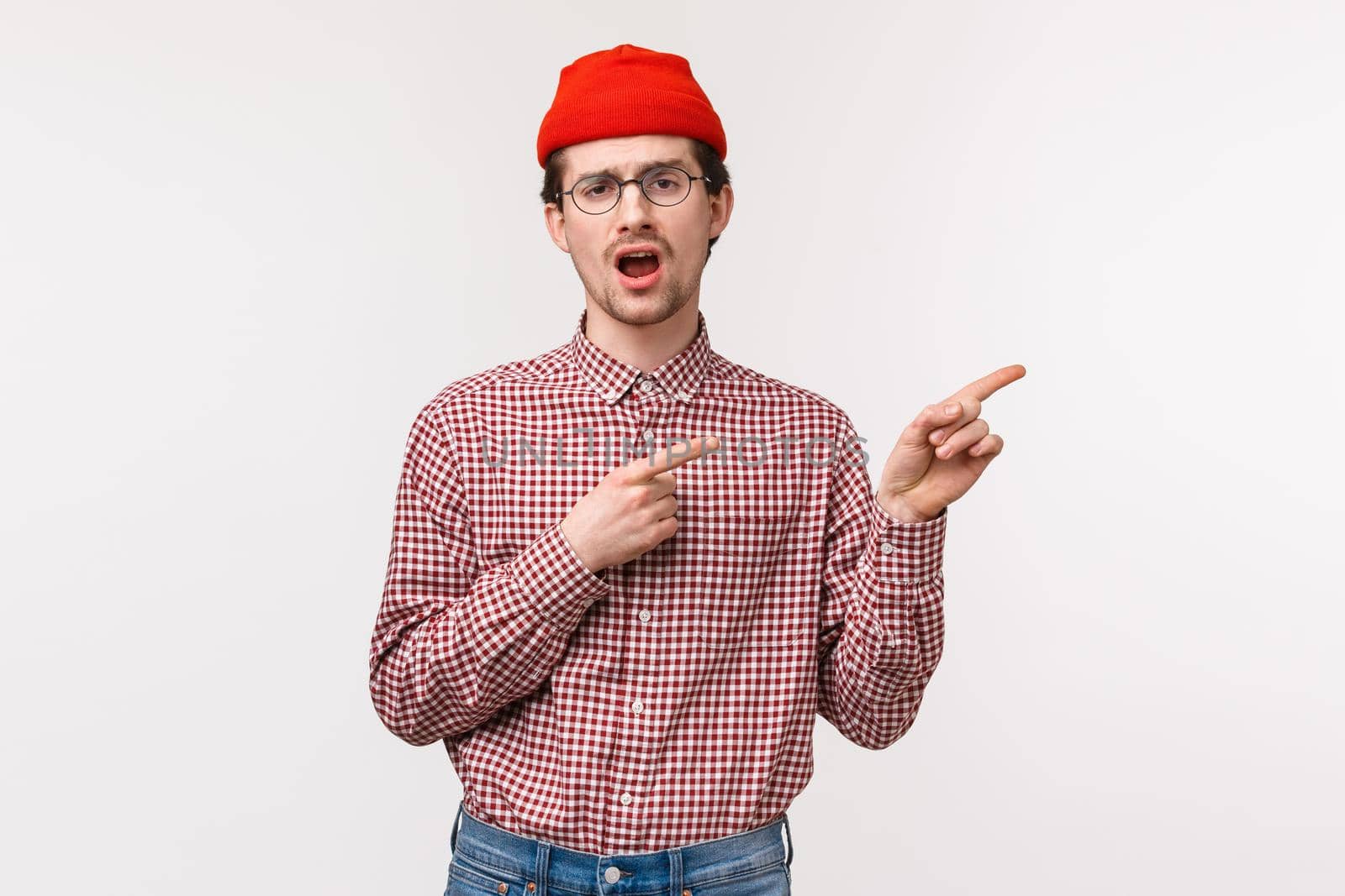 Waist-up portrait unimpressed reluctant and bored young man in glasses and red beanie yawning uninterested as pointing upper right corner at something that not worth attention, white background by Benzoix