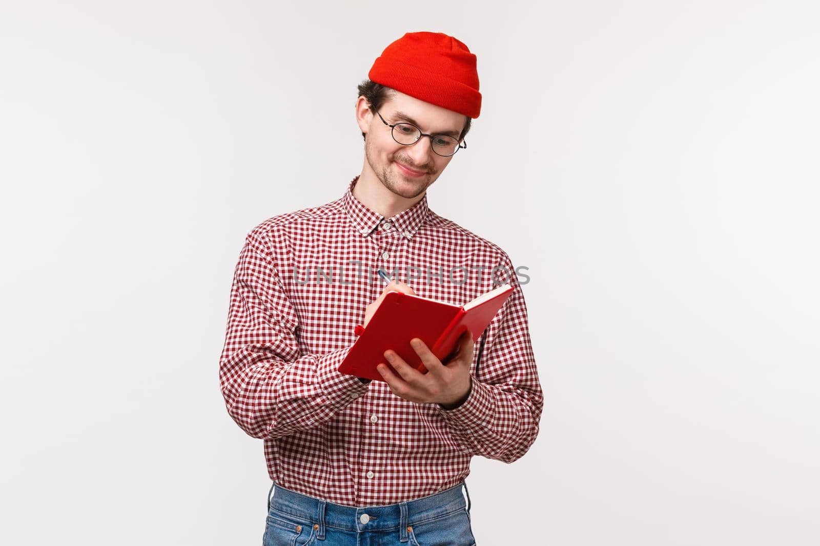 Waist-up portrait funny cute bearded guy red beanie, glasses, write down notes during lecture, making list of grocceries or have diary, smiling pleased as working on project, white background by Benzoix