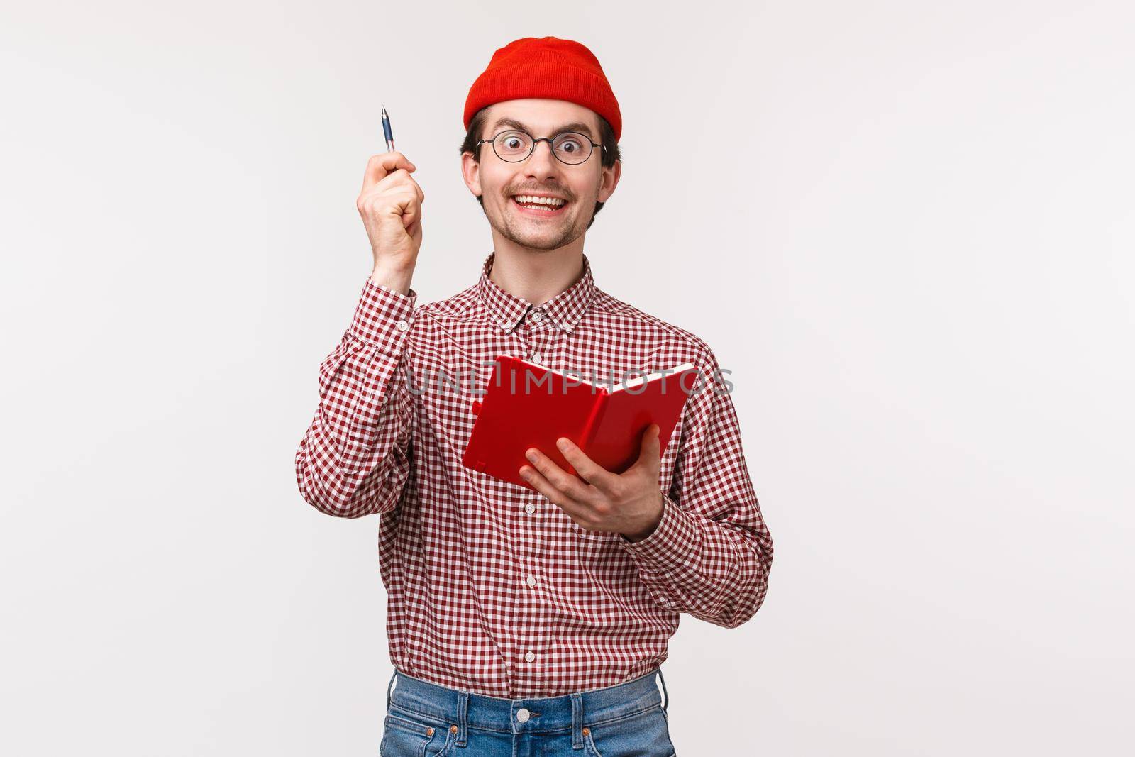 Waist-up portrait excited and thrilled young man striked with awesome idea, say eureka and lift pen up with satisfied inspired smile, holding notebook, solving difficult equation, white background.