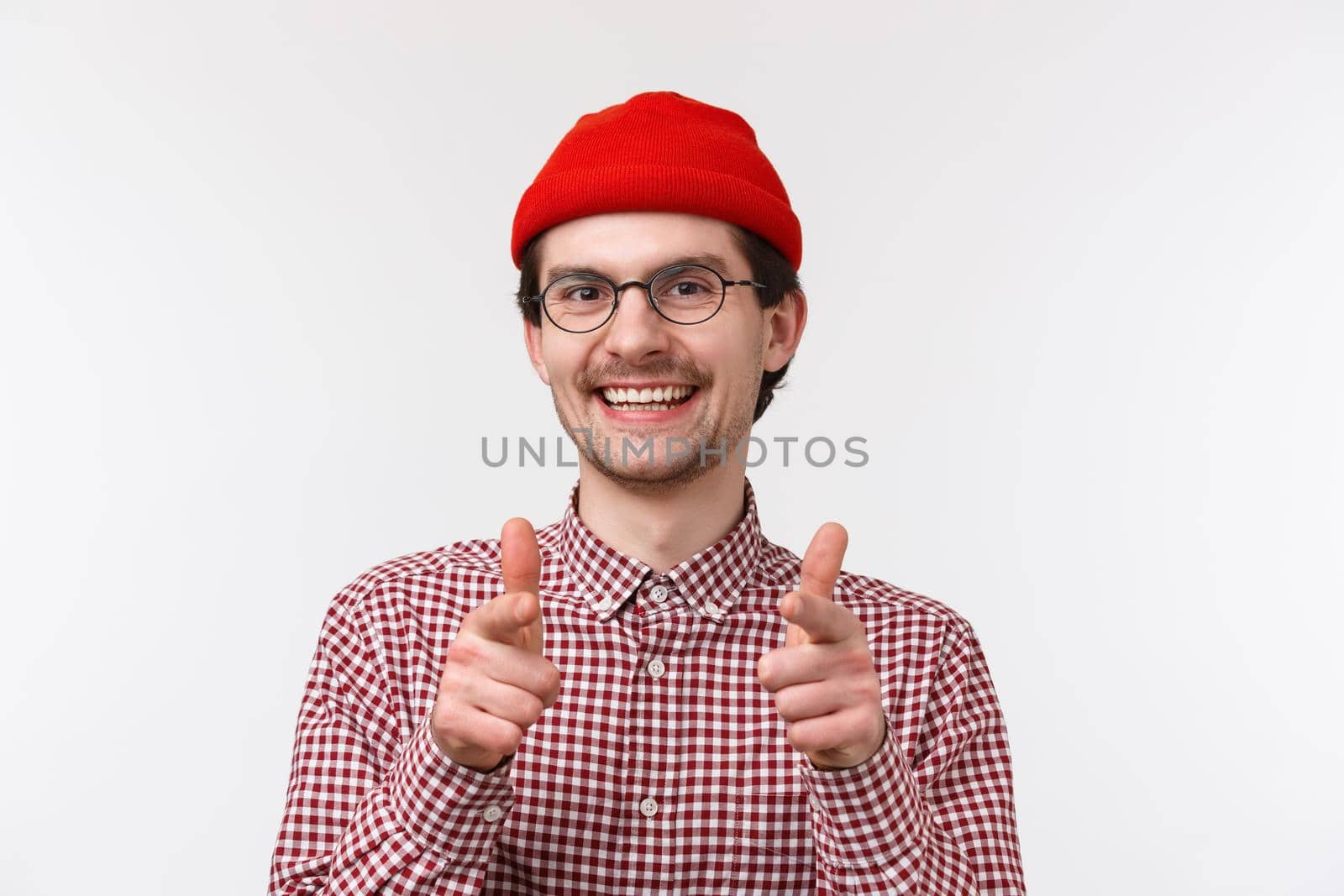 Nice work. Close-up portrait happy satisfied smiling caucasian man with beard in glasses and beanie, showing finger pistols camera praise great job, picking person, recruit to team, white background by Benzoix