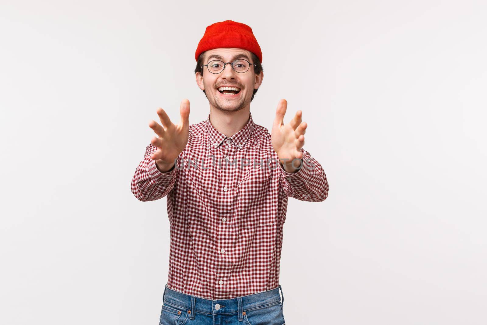 Waist-up portrait happy smiling caucasian man reaching something, raise hands to catch object, playing with friend, standing white background, waiting for pass, receive present.