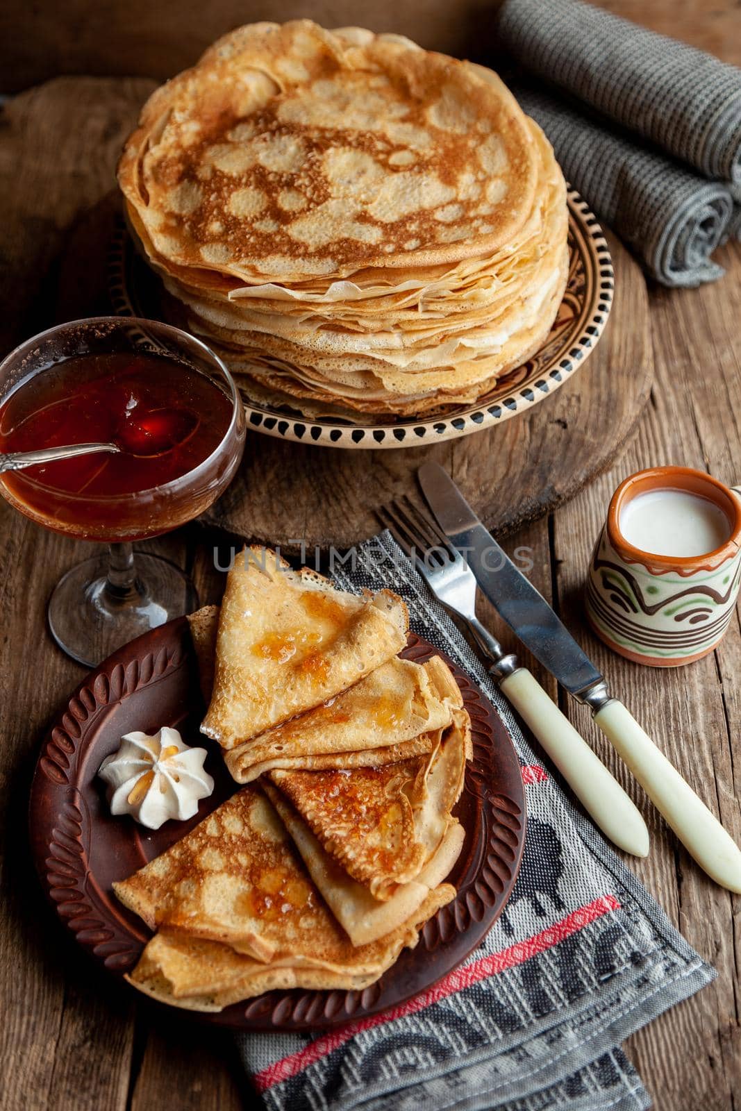 Pancake foods. A stack of thin pancakes on a plate. Russian pancake week.Shrove tide. Thin pancake with crispy crust. Homemade pastries. Pancakes for breakfast. Appetizing food.