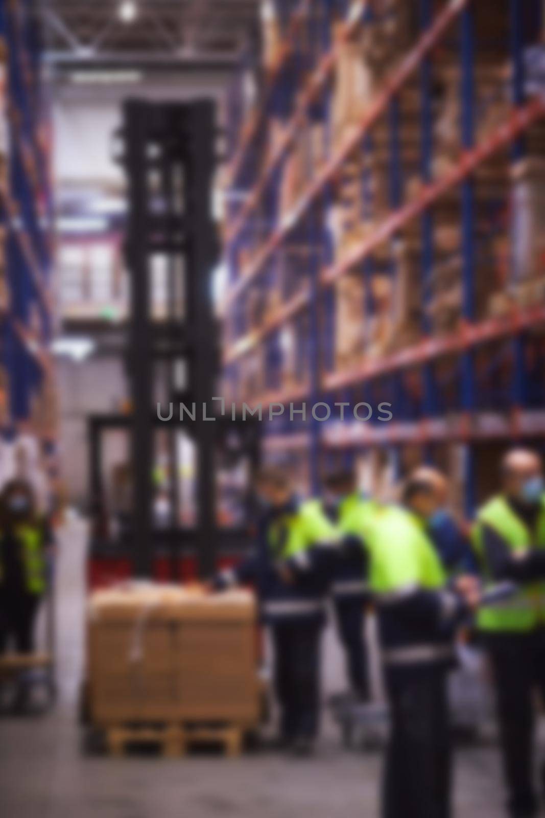 Blur warehouse background. Warehouse worker taking package in the shelf in a large warehouse in a large warehouse by sarymsakov