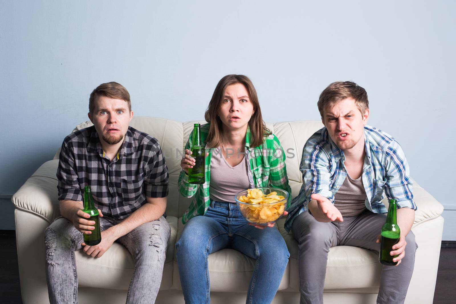 Group of friends watching sport together, Young men drink beer