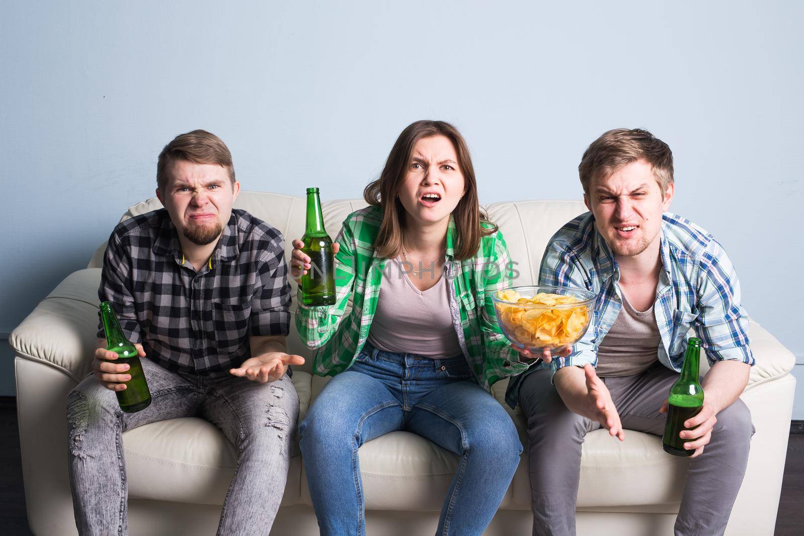Group of friends watching sport together, Young men drink beer