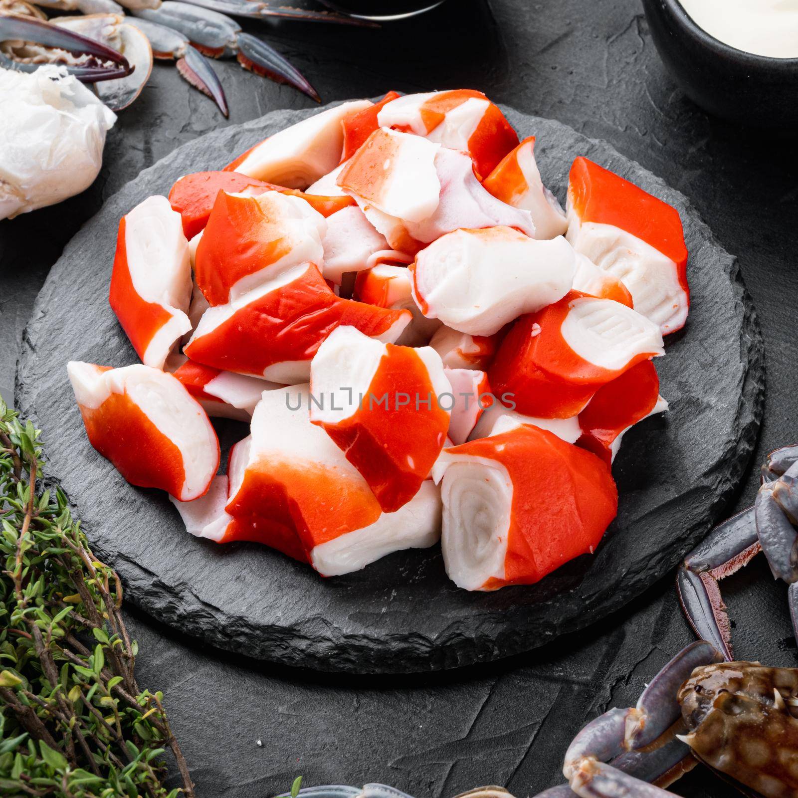 Fresh Crab meat stick surimi set, on stone board, on black background