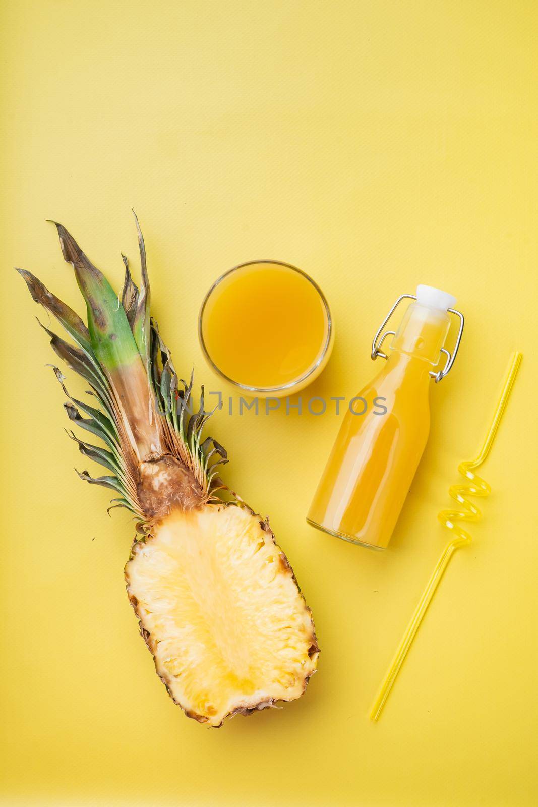 Pineapple juice set, on yellow textured summer background, top view flat lay