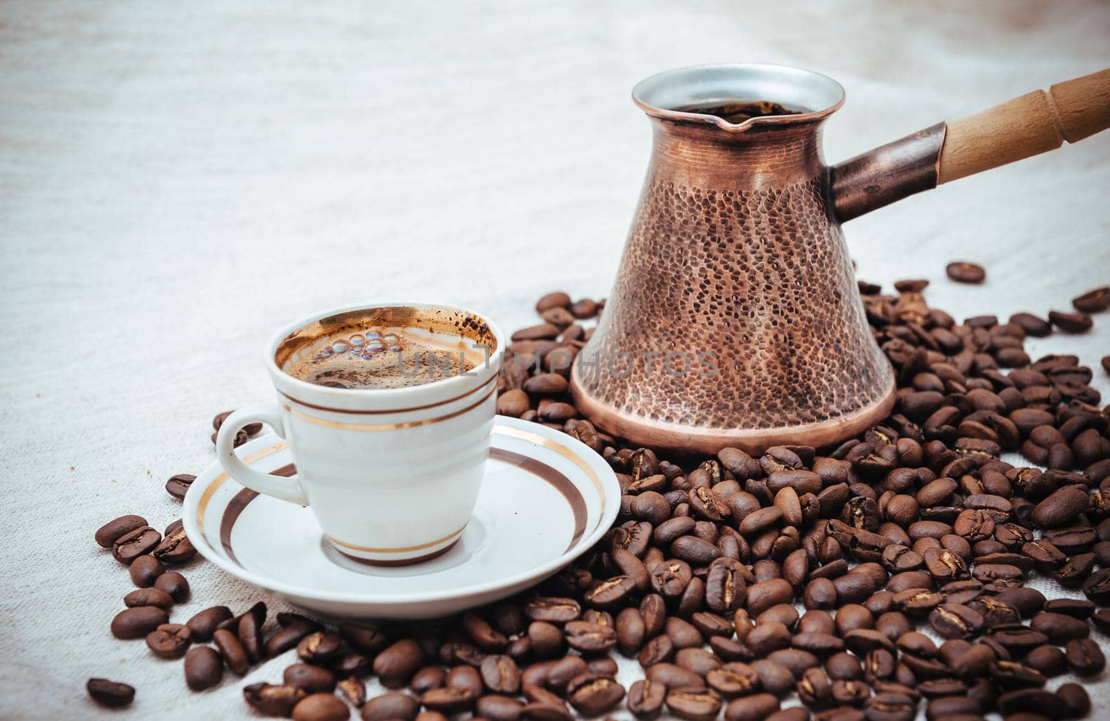 Coffee turk and cup of coffee on burlap background. coffee beans isolated on white background. roasted coffee beans by Andrii_Ko