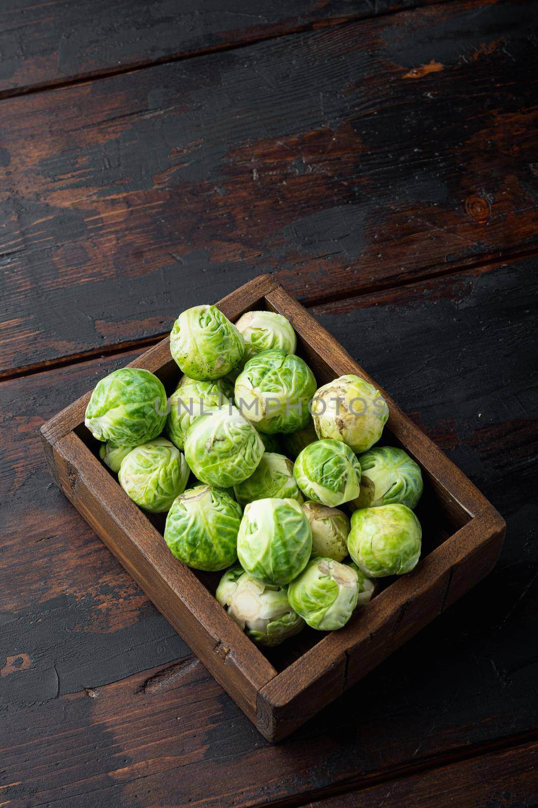Raw brussels sprouts, on old wooden table with space for text
