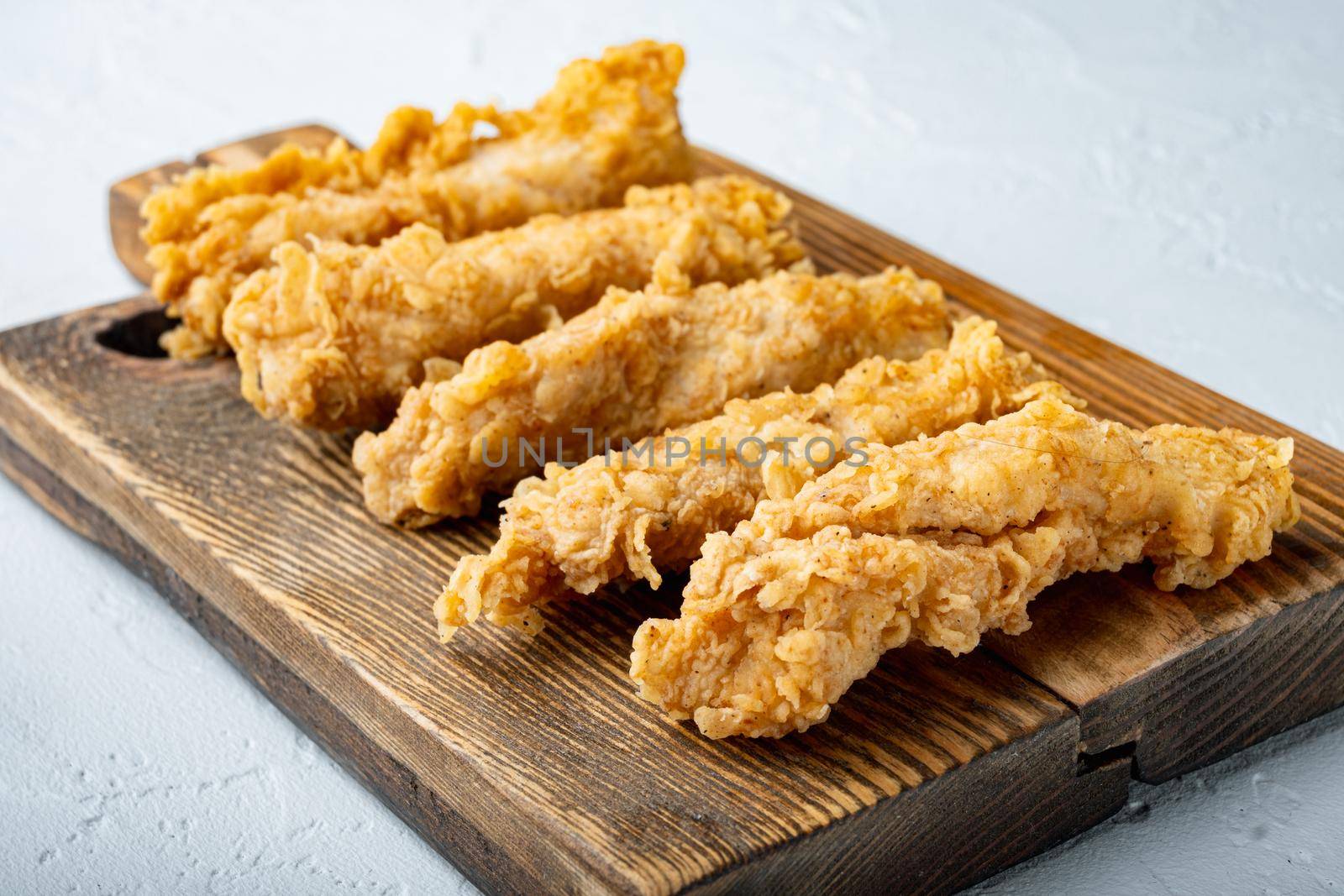 Chicken breaded breast fillet on white background.