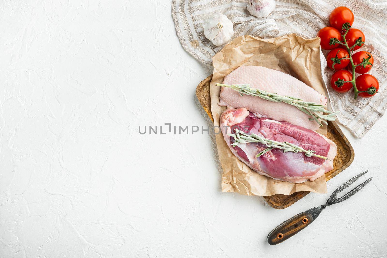 Raw duck breast set, with herbs and ingredients, on wooden tray, on white stone background, top view flat lay, with copyspace and space for text