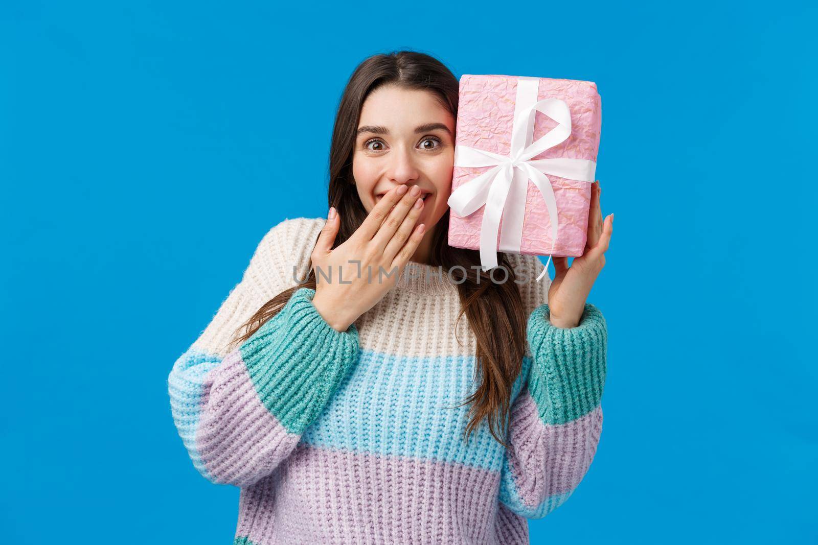 Happy cheerful cute girl guessing whats inside box, received present smiling amazed and cheerful, cant believe boyfriend bought what she wanted for christmas holidays, receive awesome gift.