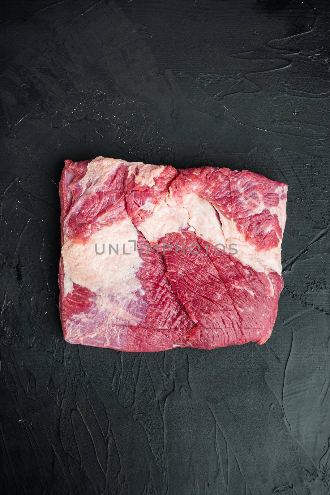 Raw Beef belly, beef brisket meat, on black stone background, top view flat lay, with copy space for text by Ilianesolenyi