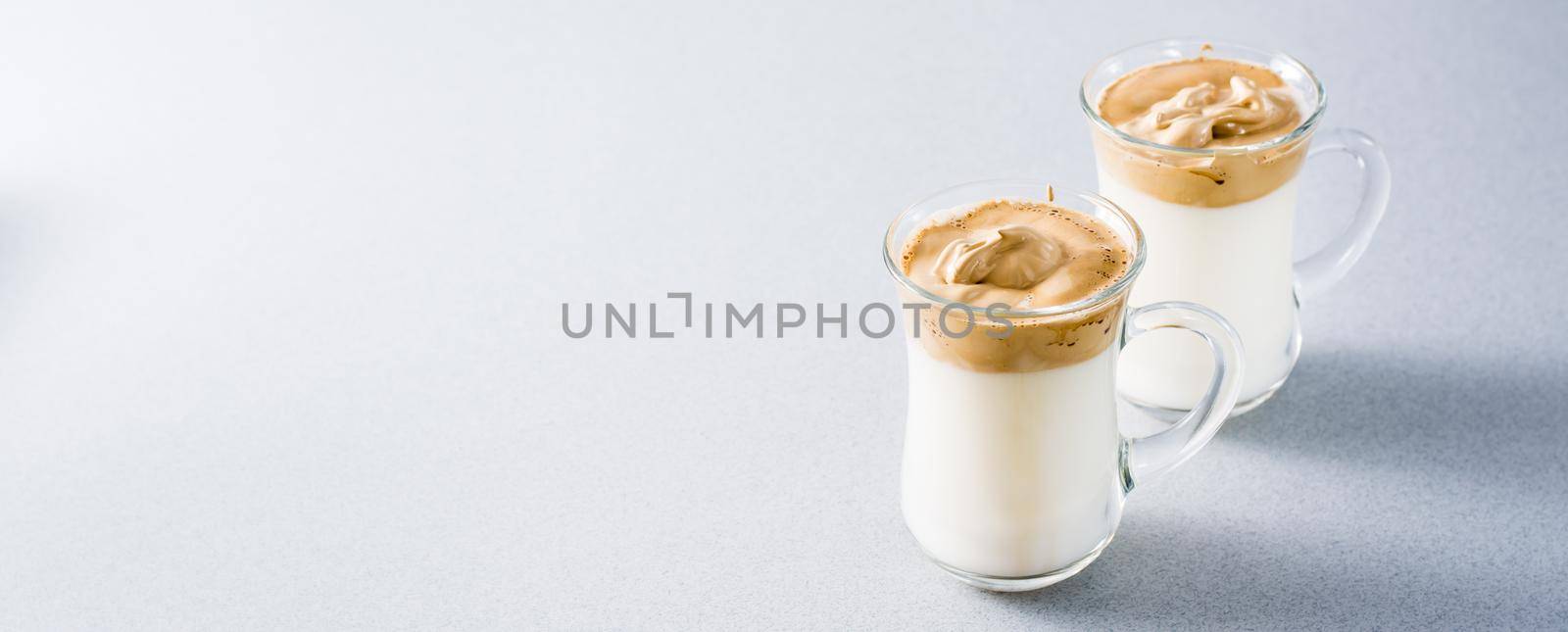 Two cups with dalgona coffee on the table. Quarantine cuisine. Copy space. Web banner