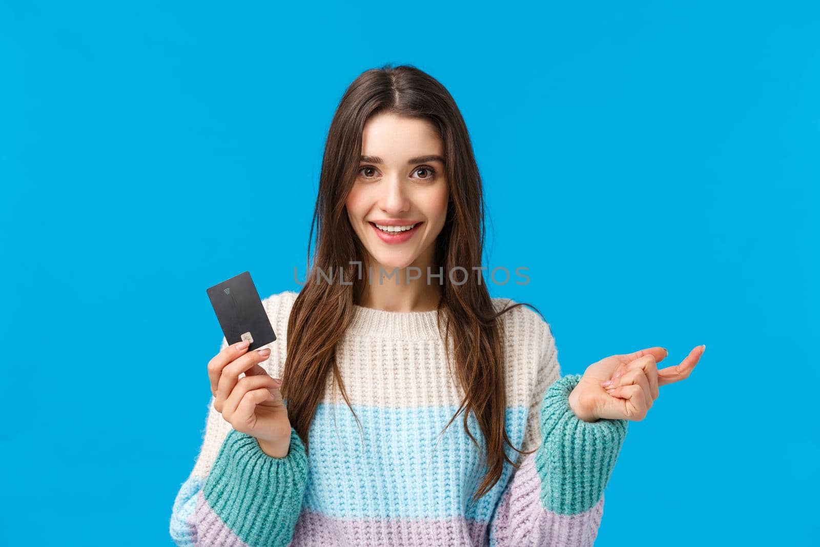 Girl counting pros of new banking system, folding fingers. Attractive female shopaholic ready waste all money on credit card during special winter discounts season, shopping, smiling camera.