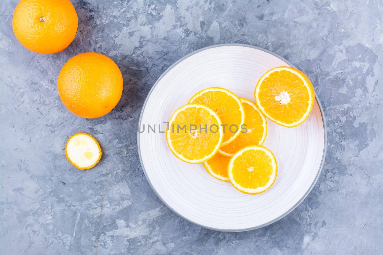 Pieces of fresh orange on a plate on the table. Vitamins, diet and vigor. Healthy eating. Top view