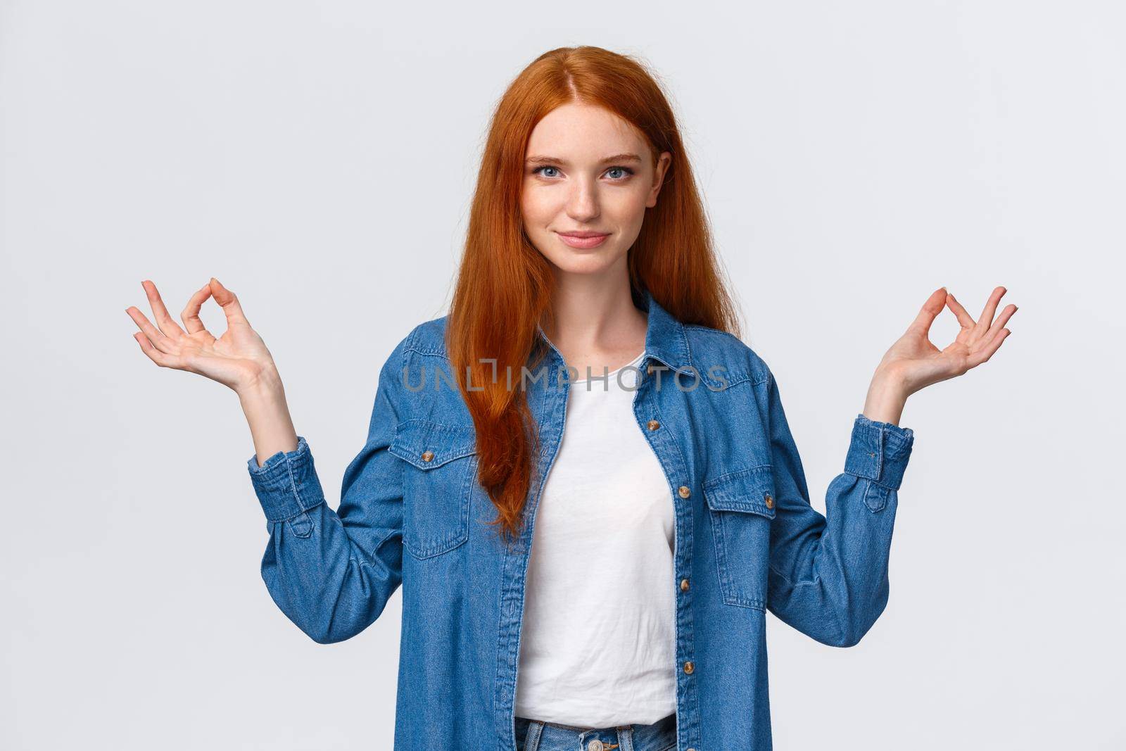 Waist-up portrait confident and relieved, patient good-looking redhead woman calm down daily yoga practice with app, hold hands sideways zen gesture in lotus pose, look assertive camera.