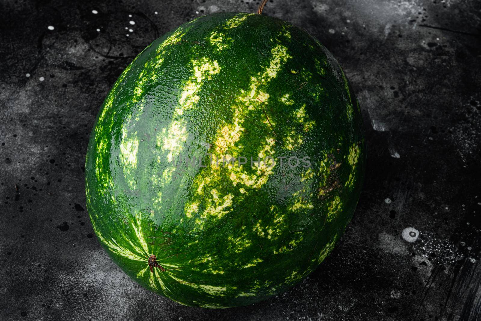 Ripe single full watermelon berry set, on black dark stone table background