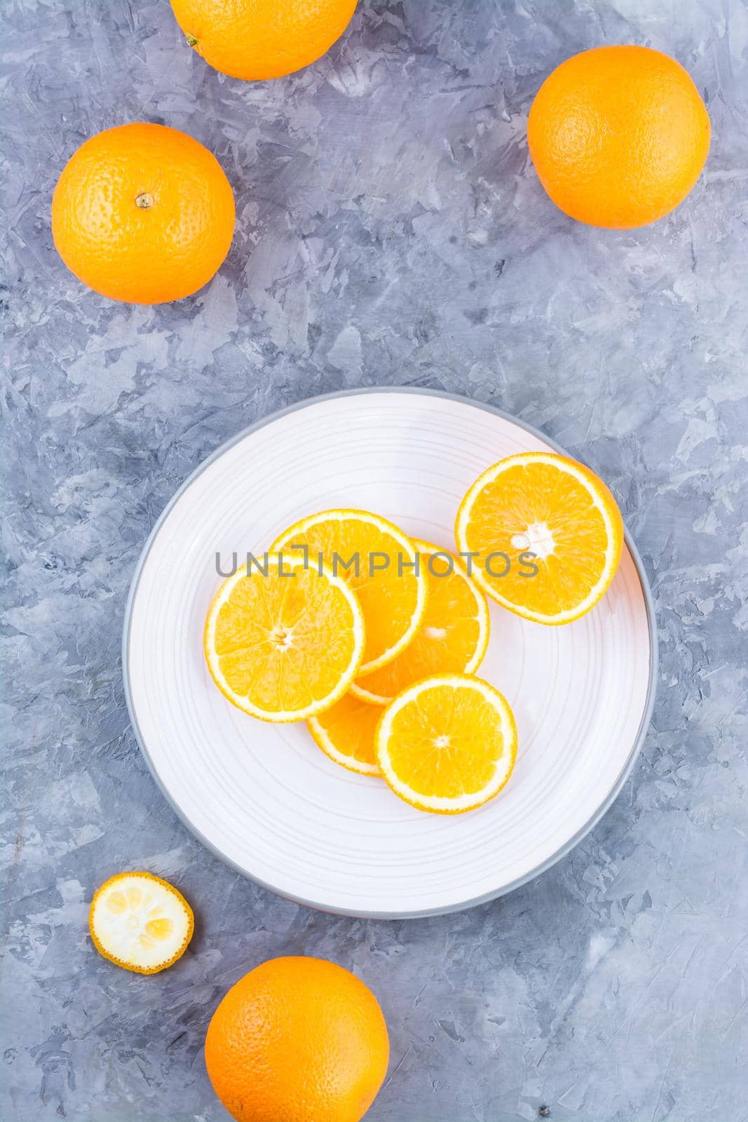 Pieces of fresh orange on a plate on the table. Vitamins, diet and vigor. Healthy eating. Top and vertical view