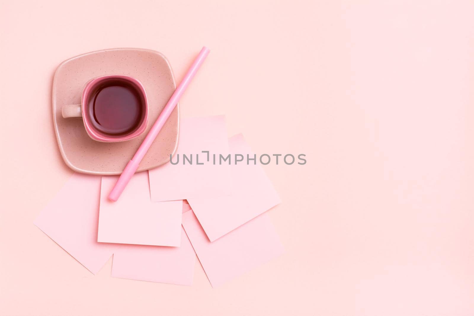 The concept is pink. Pink drink in a coffee cup, writing sheets and pen on a pink background. Top view. Copy space by Aleruana