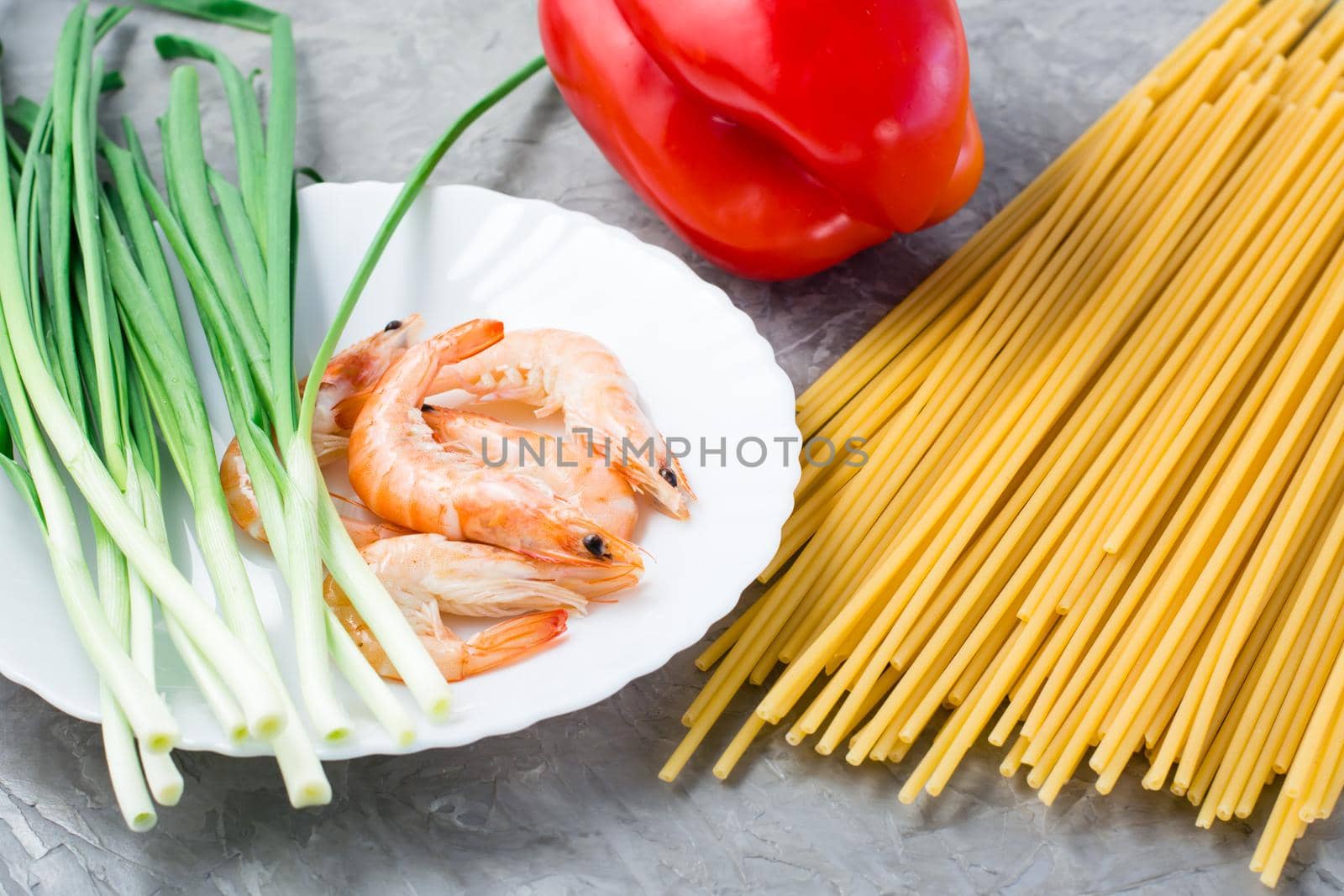 Ingredients for making udon and wok noodles with shrimps, peppers and onions on the table. Chinese food