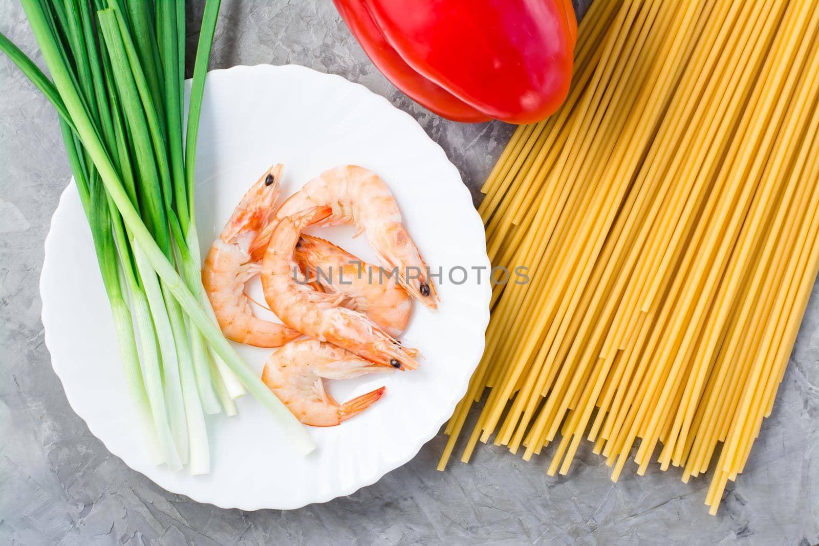 Ingredients for making udon and wok noodles with shrimps, peppers and onions on the table. Chinese food. Top view