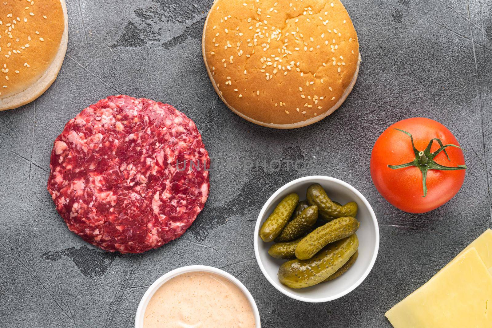 Beef burger ingredients set, on gray stone background, top view flat lay