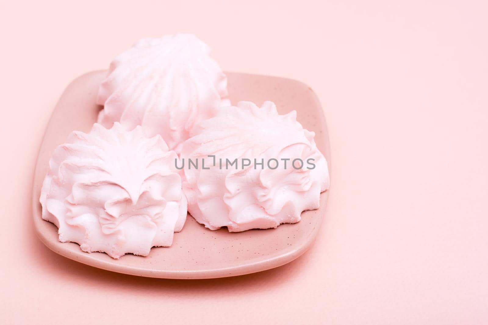 The concept is pink. Pink marshmallows on a saucer on a pink background by Aleruana