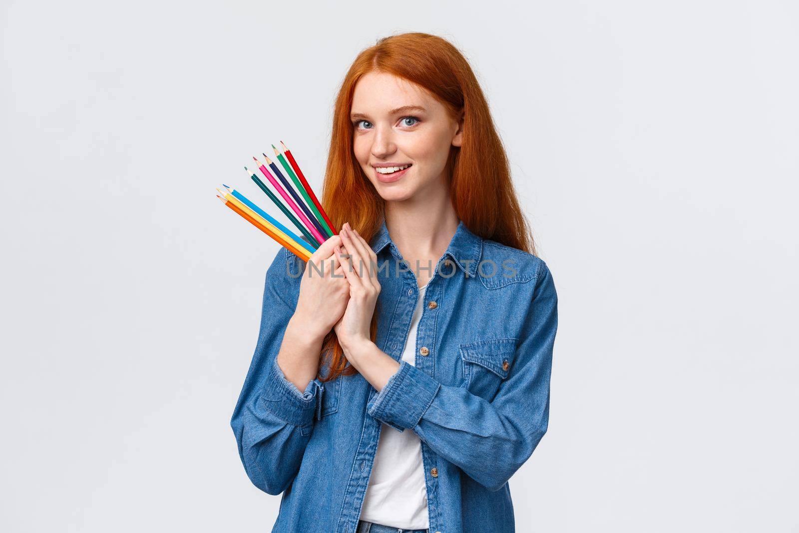 Waist-up portrait dreamy and talented good-looking redhead female student create design project, draw architecture, holding colored pencils and smiling camera happy, white background.