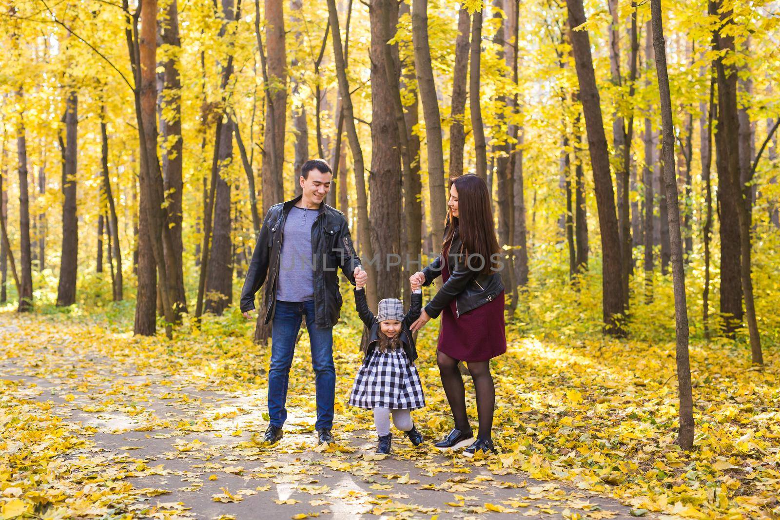 Children, nature and family concept - Portrait of happy family over autumn park background.