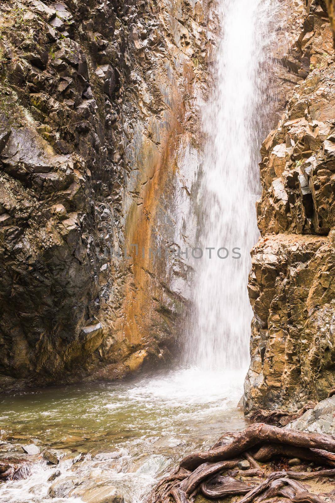 Autumn waterfall with rocks and leaves in Troodos mountains in Cyprus by Satura86