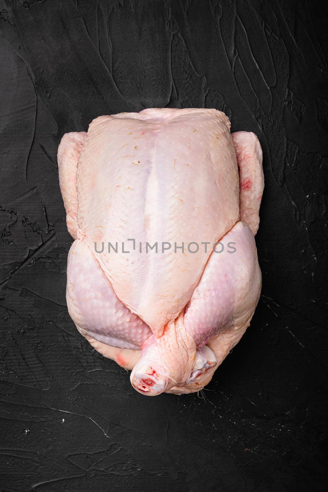 Whole chicken set, on black dark stone table background, top view flat lay, with copy space for text