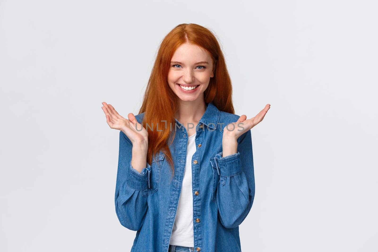 Bravo, very good. Impressed alluring smiling happy redhead woman, wear denim shirt, clap hands, applause and grinning joyfully, pleased with awesome performance, standing white background praising.