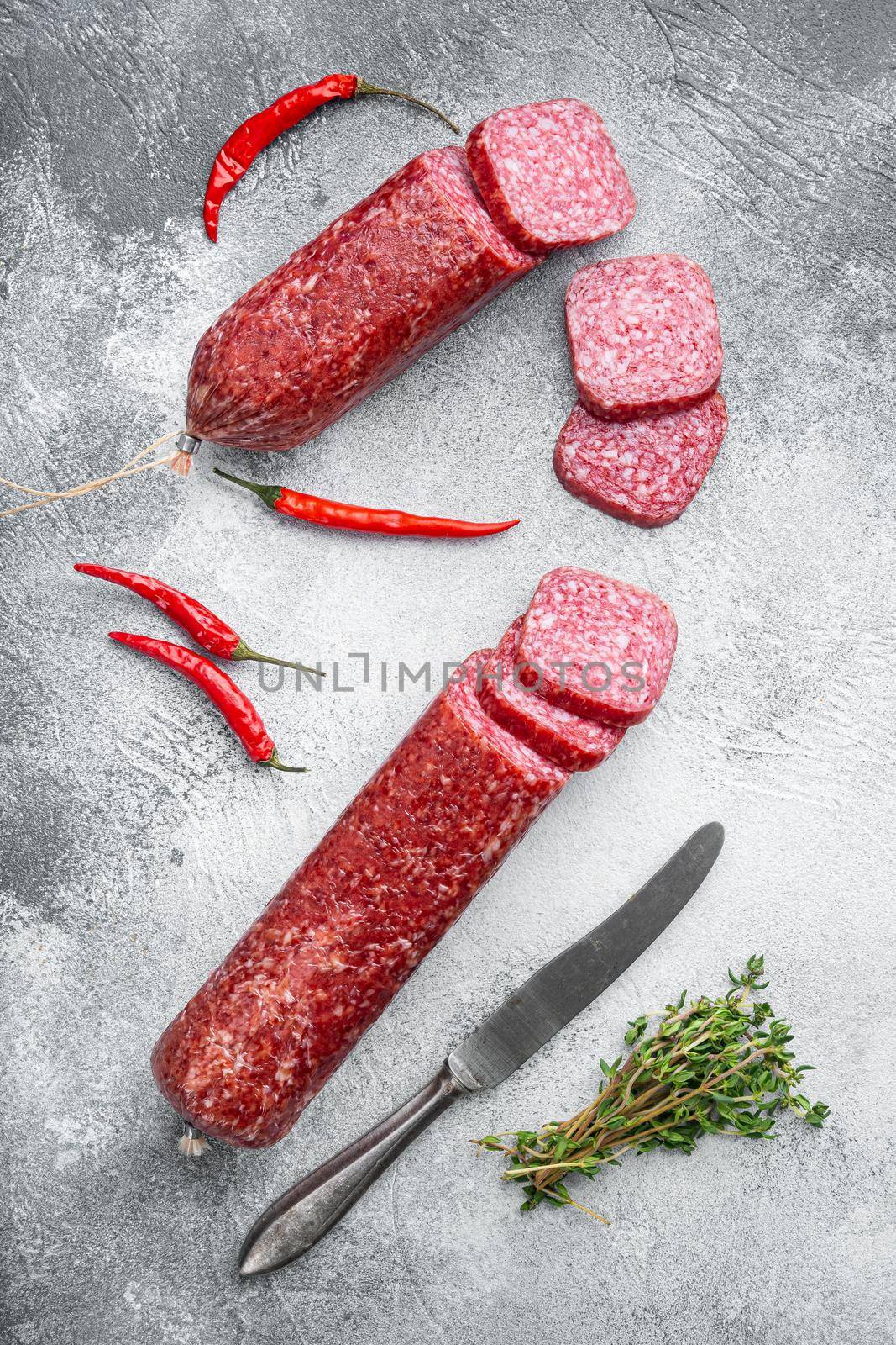 Sausage fresh rosemary and spices, on gray stone table background, top view flat lay by Ilianesolenyi