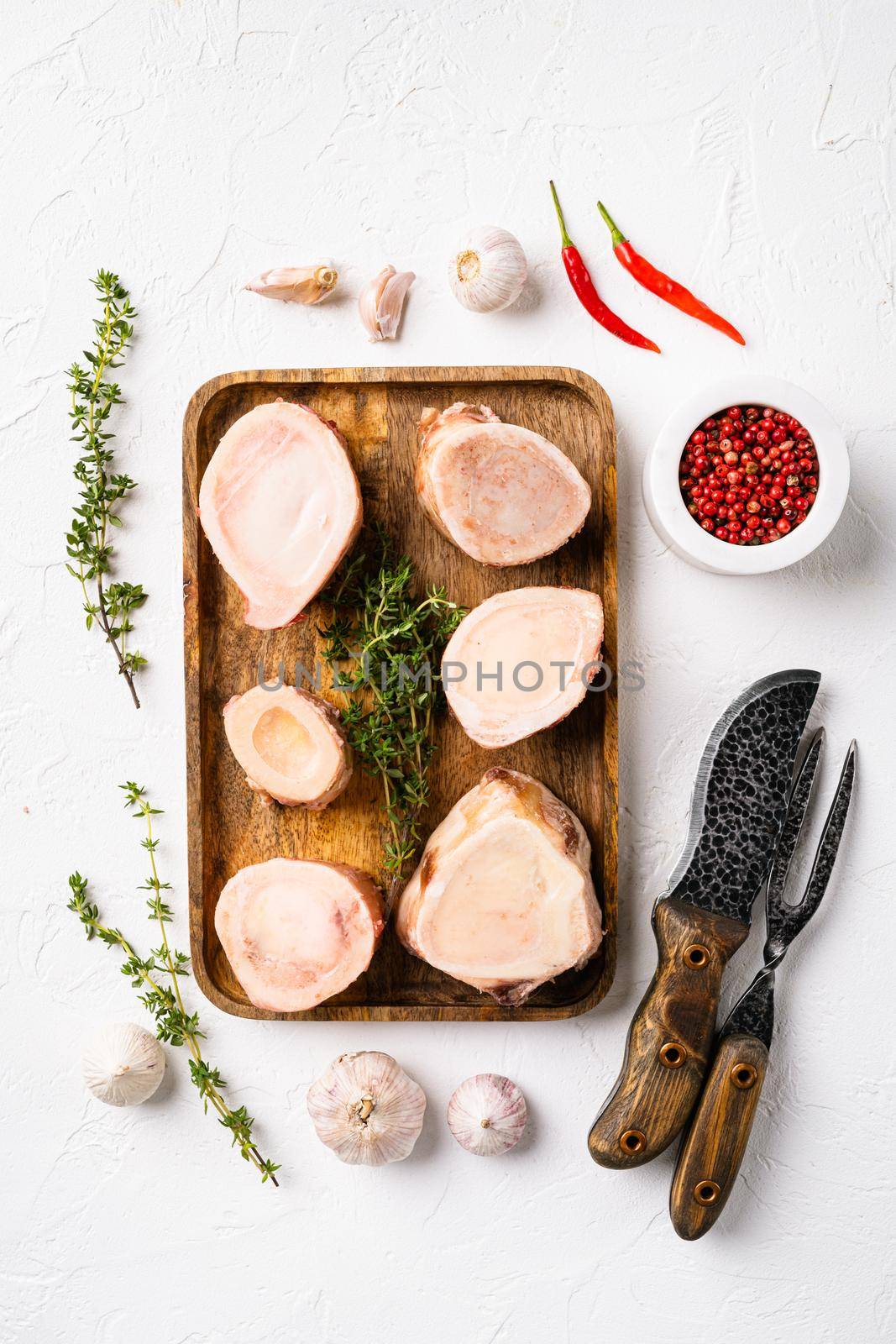 Raw bone cut veal beef set, on white stone table background, top view flat lay
