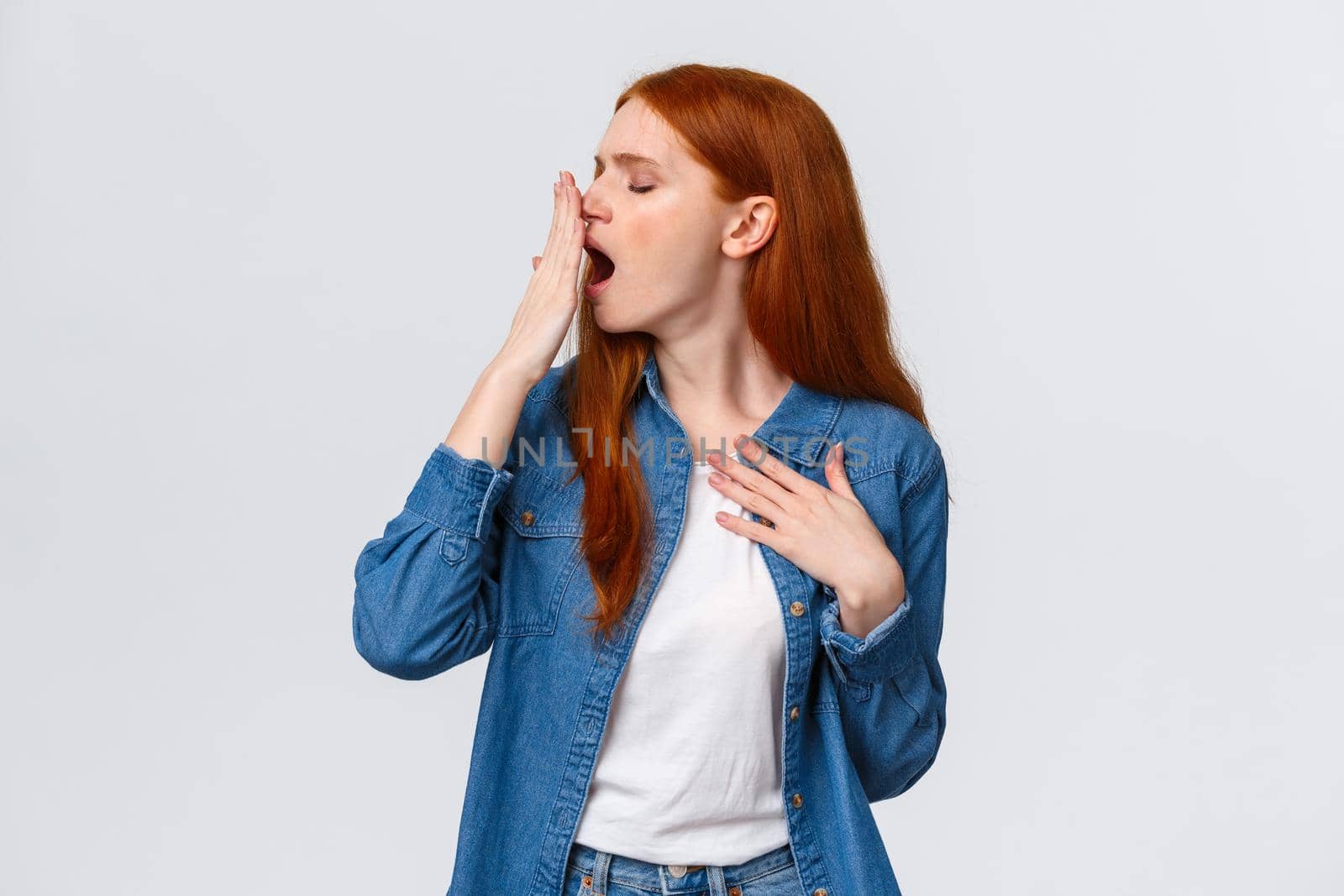 Waist-up portrait lovely redhead girl want sleep, feeling tired or bored, turn head away and yawn, cover opened mouth with palm, yawning over white background after boring class, white background by Benzoix
