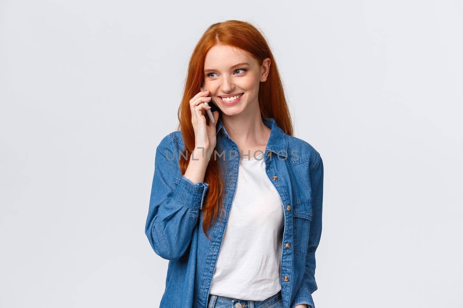 Girl calling boyfriend pick her up after classes. Attractive outgoing redhead woman talking on phone, smiling carefree, look away as having casual conversation on smartphone, white background by Benzoix