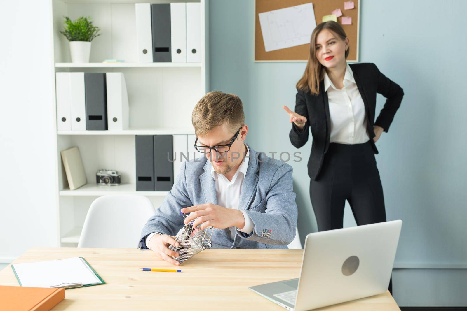 Business, emotions and people concept - Disgruntled boss watch as the employee works