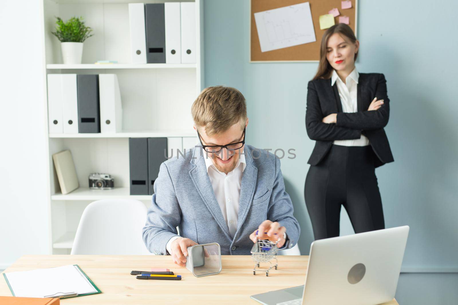 Business, emotions and people concept - Disgruntled boss watch as the employee works