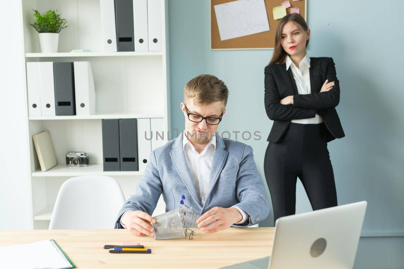 Business, emotions and people concept - Disgruntled boss watch as the employee works