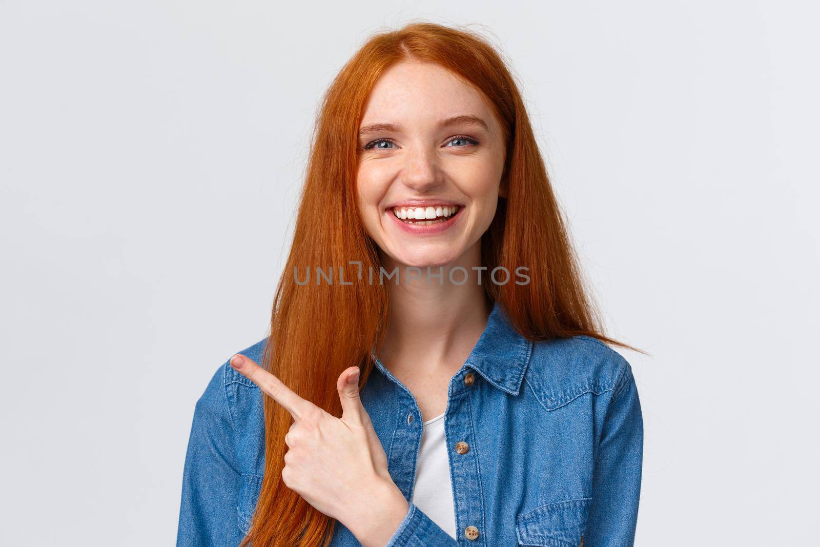 Close-up portrait outgoing good-looking cheerful redhead teenage girl in casual outfit, laughing and talking, discuss recent event, pointing finger left at banner, recommend advertisement by Benzoix